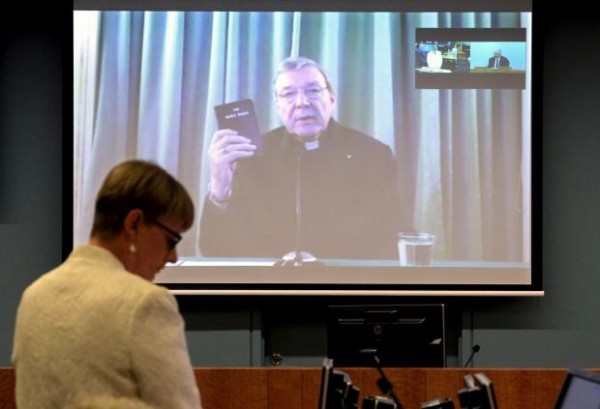 Senior Counsel Assisting Gail Furness stands in front of a screen displaying Australian Cardinal George Pell as he holds a bible while appearing via video link from a hotel in Rome, Italy to testify at the Australia's Royal Commission into Institutional Response to Child Sexual Abuse in Sydney, Australia, February 29, 2016.