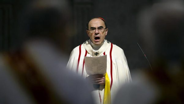 French Cardinal Philippe Barbarin, Archbishop of Lyon, leads a mass for migrants in the Saint-Jean Cathedral, in Lyon, central France, Sunday, April 3, 2016.