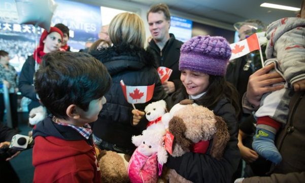 Syrian refugees arrive at Vancouver international airport. A Canadian priest has been charged over stealing funds which were to be used for resettlement programs.